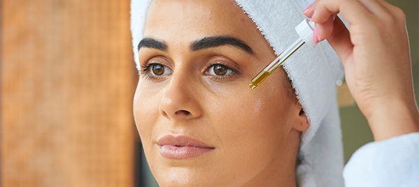 Image Of Woman Putting Sandalwood On Skin